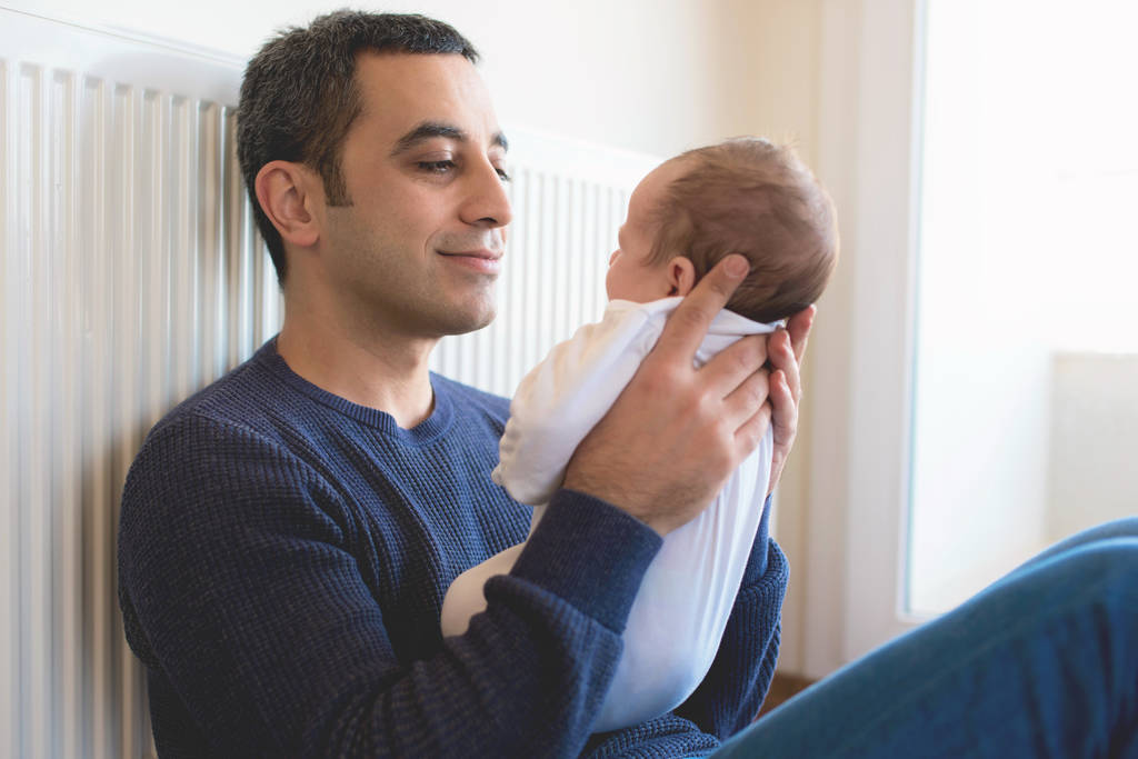 Dad bonding with newborn baby during lockdown